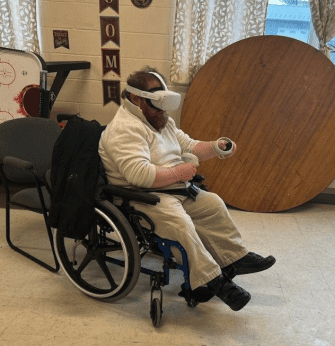 Man in wheelchair using VR headset to explore career options